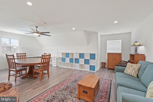 living area featuring visible vents, baseboards, ceiling fan, light wood-type flooring, and recessed lighting