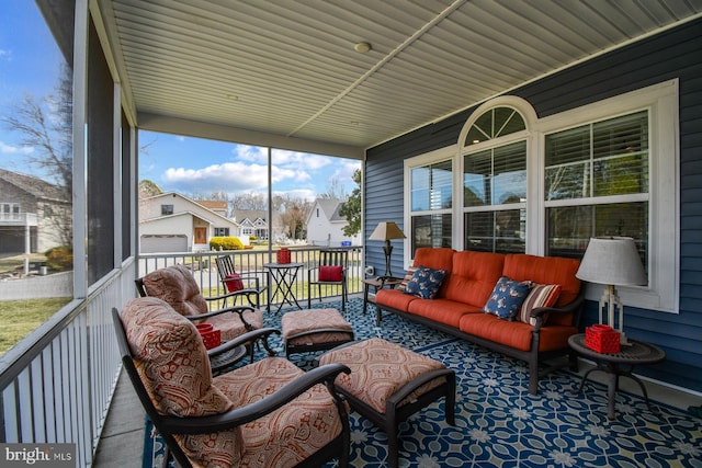 sunroom / solarium featuring a residential view