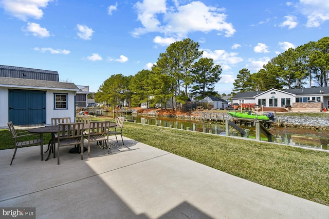 view of patio featuring a residential view, outdoor dining area, and a water view