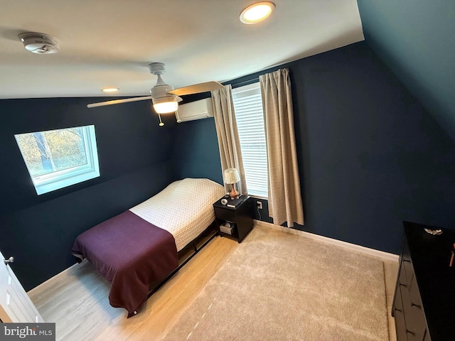 bedroom featuring a wall mounted air conditioner, ceiling fan, baseboards, and lofted ceiling