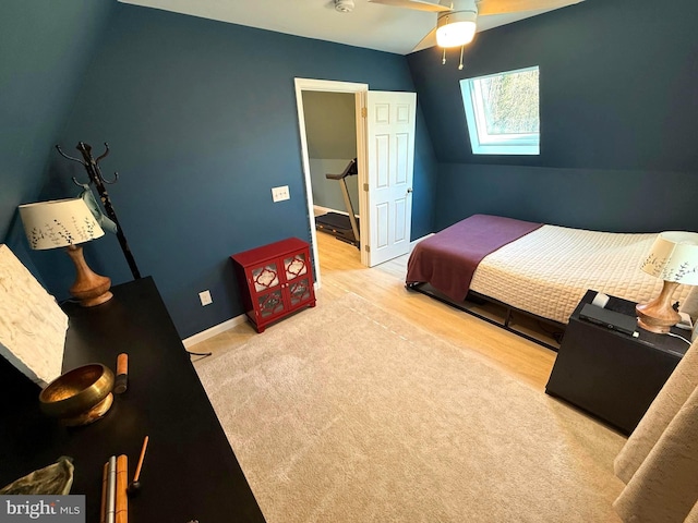 bedroom featuring vaulted ceiling, wood finished floors, and baseboards