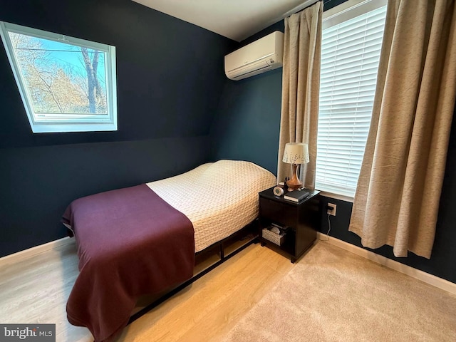 bedroom with baseboards and a wall mounted air conditioner