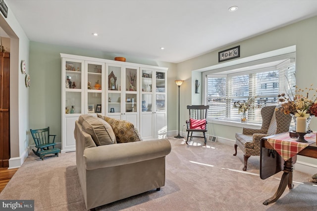 sitting room featuring recessed lighting, baseboards, and light colored carpet