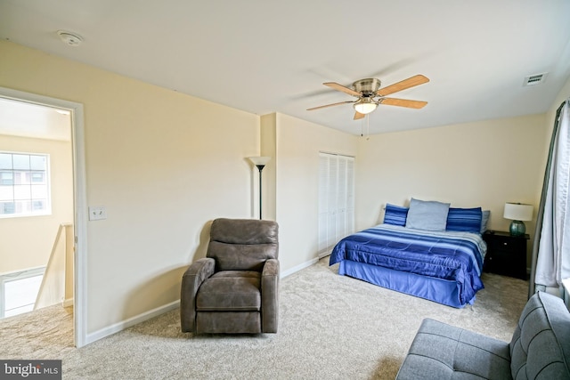 carpeted bedroom featuring a ceiling fan, baseboards, and visible vents