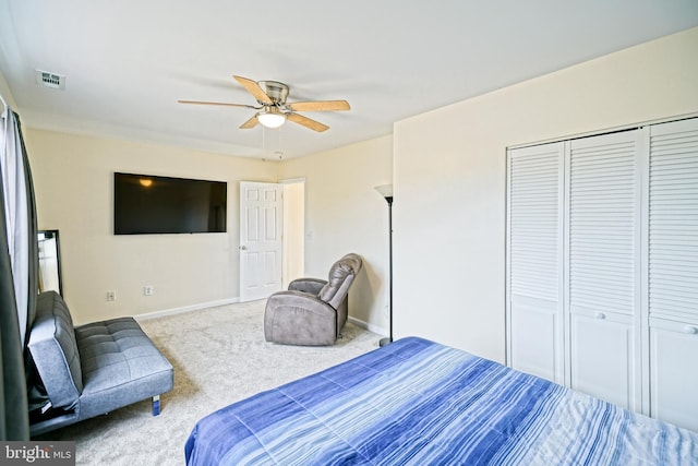 carpeted bedroom with a closet, visible vents, a ceiling fan, and baseboards