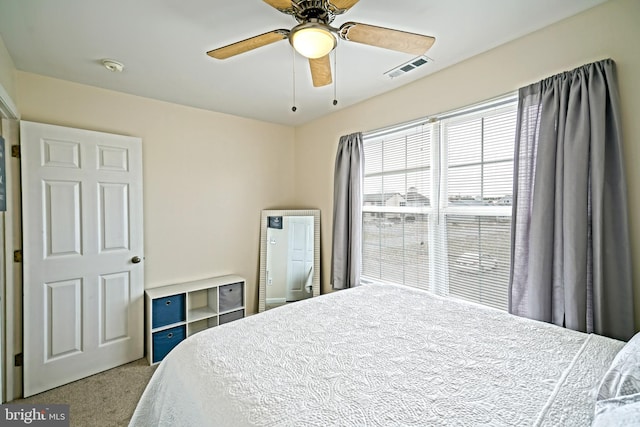 bedroom featuring carpet flooring, visible vents, and ceiling fan