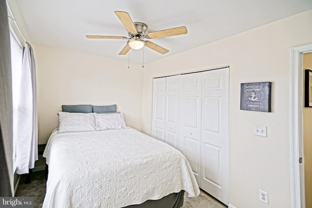 bedroom with a closet, carpet flooring, and a ceiling fan