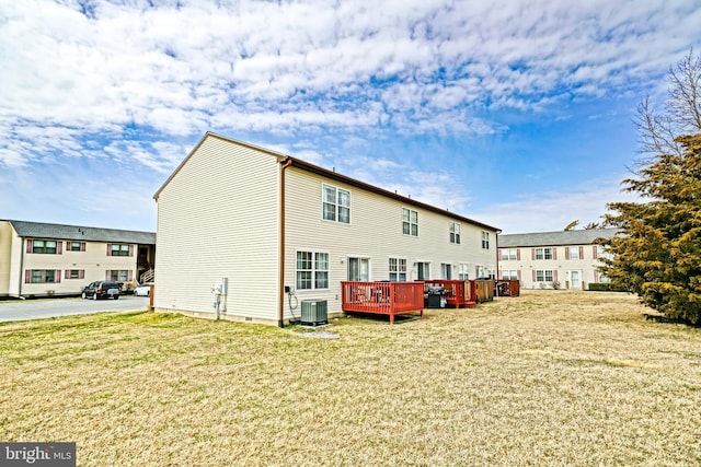 back of house with a lawn, cooling unit, and a deck