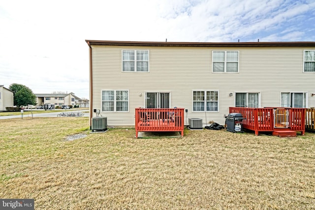 back of house with a deck, central AC unit, and a lawn