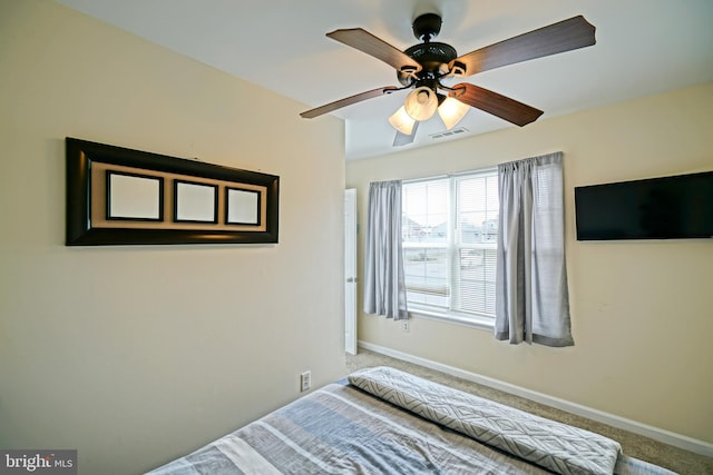 bedroom featuring ceiling fan, carpet, visible vents, and baseboards