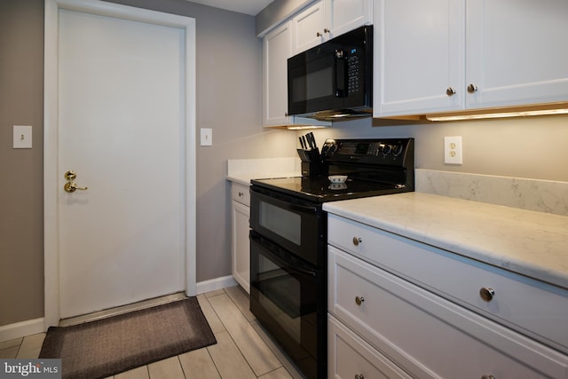 kitchen featuring baseboards, black appliances, white cabinets, and light countertops