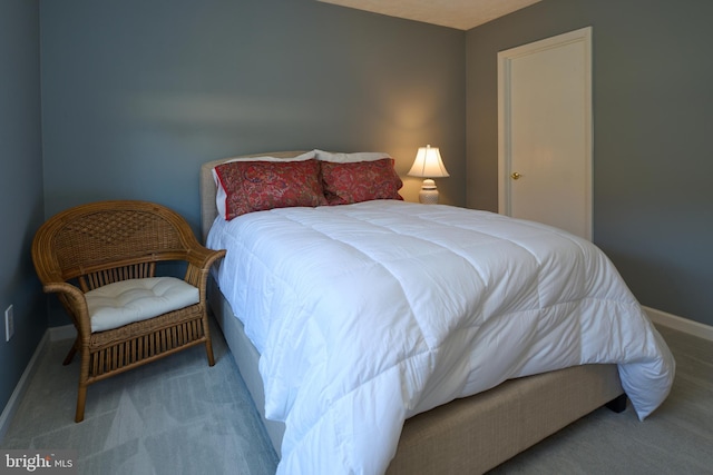 bedroom with carpet flooring and baseboards