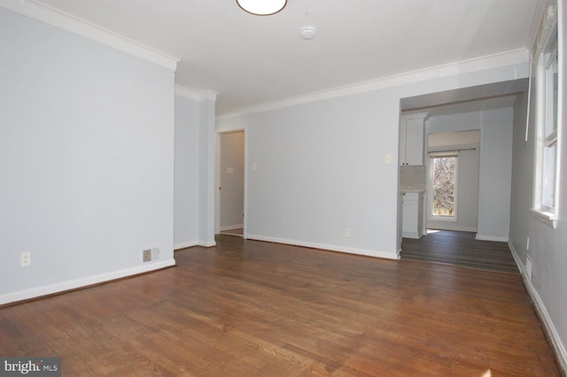 empty room with dark wood finished floors, baseboards, and visible vents