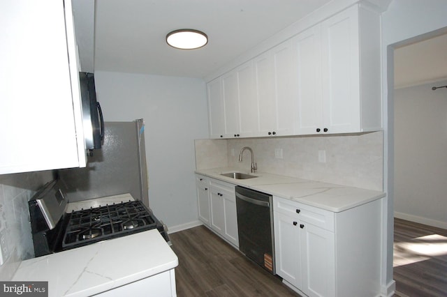 kitchen featuring black gas range oven, a sink, decorative backsplash, dark wood-type flooring, and stainless steel dishwasher