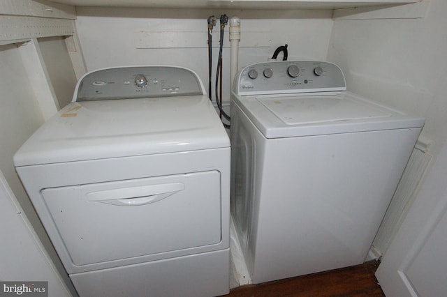 clothes washing area with independent washer and dryer and laundry area