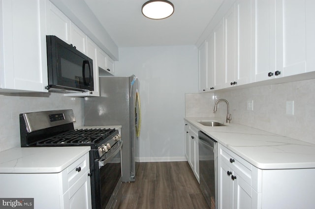 kitchen featuring backsplash, dark wood finished floors, white cabinets, stainless steel appliances, and a sink