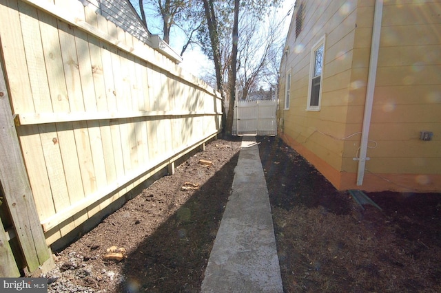 view of side of home featuring fence