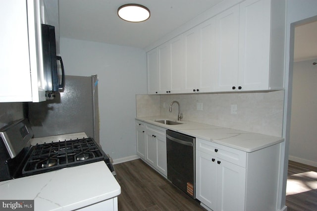 kitchen with stainless steel range with gas cooktop, dark wood finished floors, dishwasher, decorative backsplash, and a sink