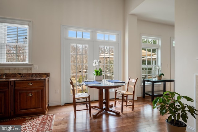 dining room featuring light wood-style flooring and baseboards