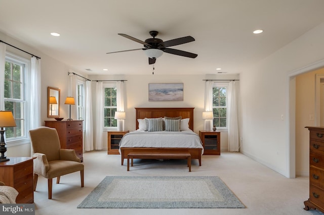 bedroom featuring recessed lighting, baseboards, light colored carpet, and a ceiling fan