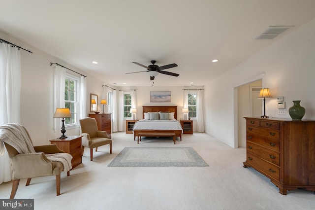 bedroom with recessed lighting, visible vents, light colored carpet, and a ceiling fan