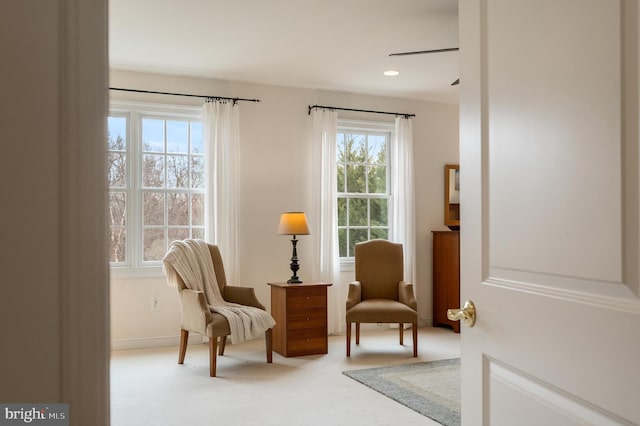 living area featuring recessed lighting and carpet