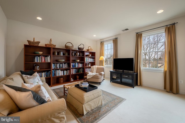 living area featuring recessed lighting, visible vents, carpet floors, and baseboards