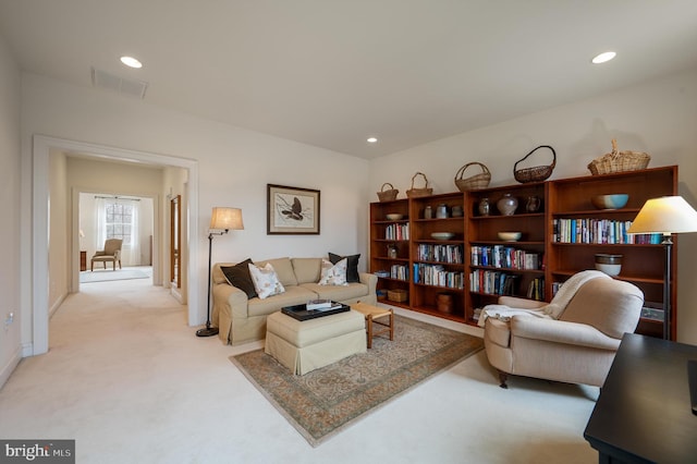 living area with recessed lighting, visible vents, light carpet, and baseboards