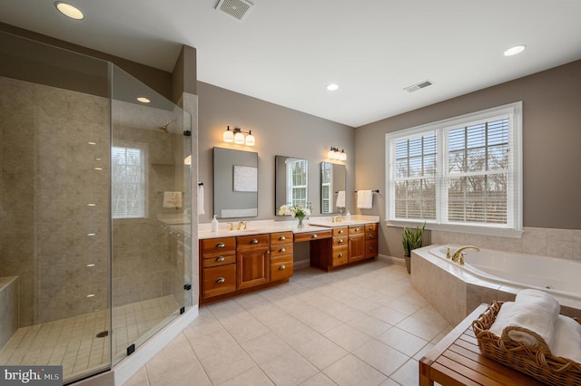 full bathroom with a shower stall, double vanity, and visible vents