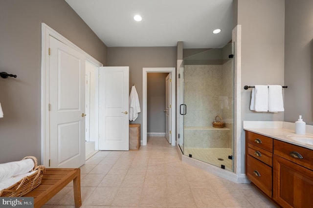 bathroom featuring tile patterned floors, recessed lighting, a stall shower, and vanity