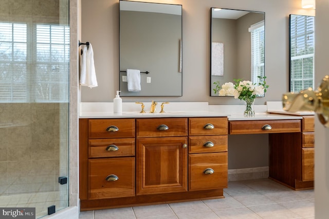 bathroom with tile patterned flooring, vanity, a healthy amount of sunlight, and a stall shower