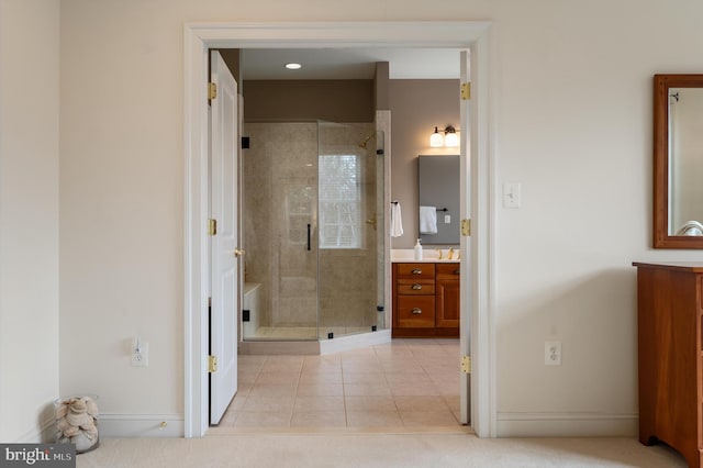 full bathroom featuring a stall shower, vanity, and tile patterned flooring