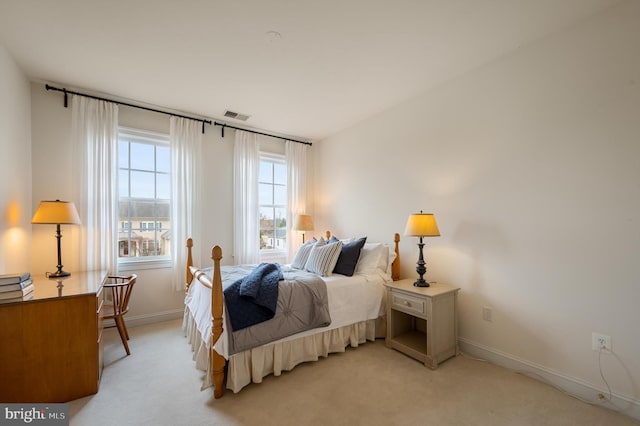 bedroom featuring light carpet, visible vents, and baseboards