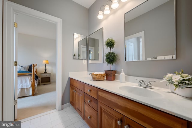 full bath featuring double vanity, tile patterned floors, ensuite bath, and a sink