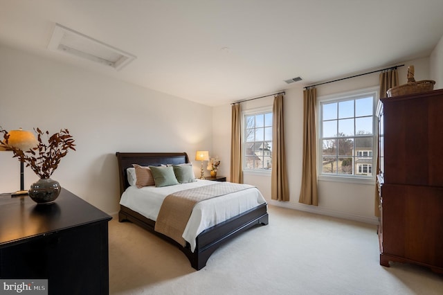 bedroom with visible vents, light colored carpet, attic access, and baseboards