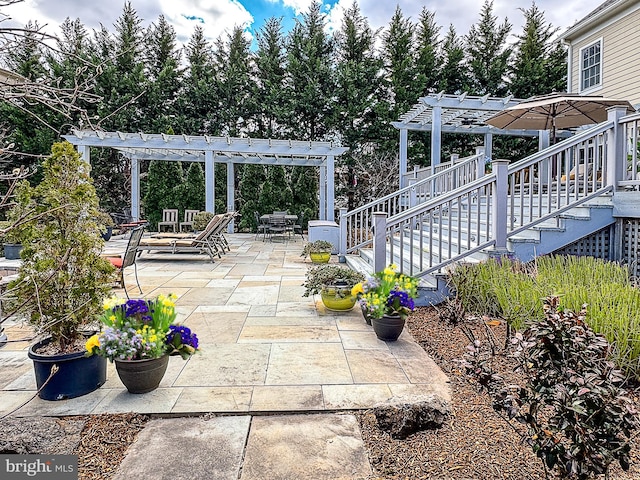 view of patio featuring stairs and a pergola