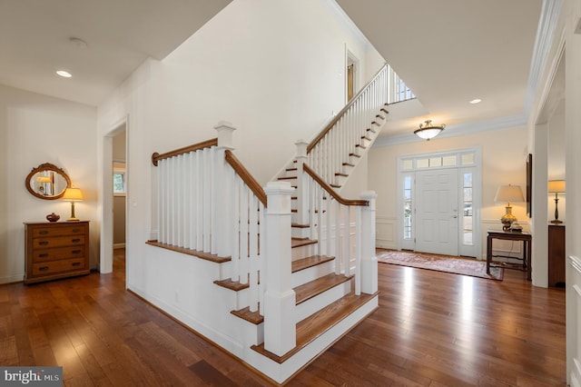 foyer with crown molding, stairway, recessed lighting, and wood-type flooring