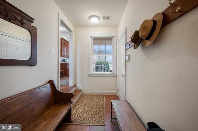 entryway with tile patterned floors, visible vents, and baseboards