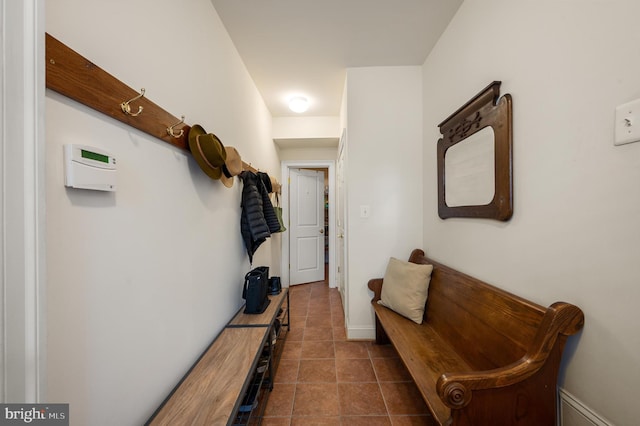 mudroom featuring baseboards and dark tile patterned flooring