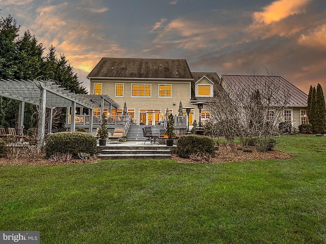 back of house with a yard, a pergola, and a wooden deck