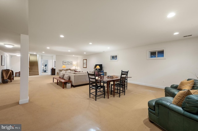 dining area with light carpet, recessed lighting, stairs, and baseboards