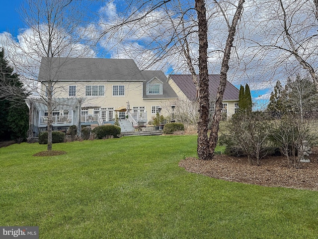 rear view of house with a lawn, a pergola, and a deck