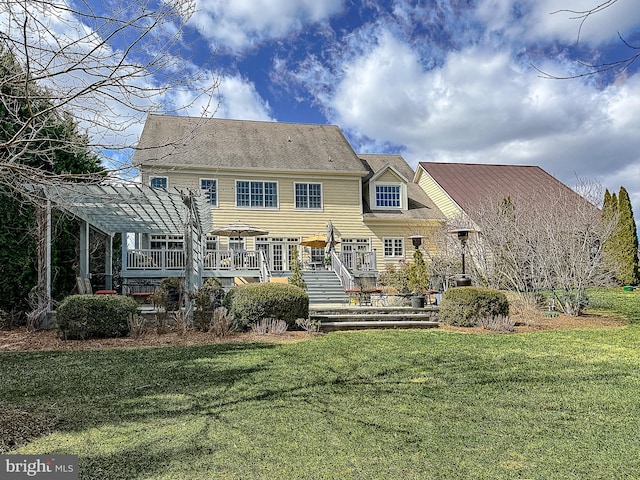 rear view of house with a lawn, a pergola, and a wooden deck