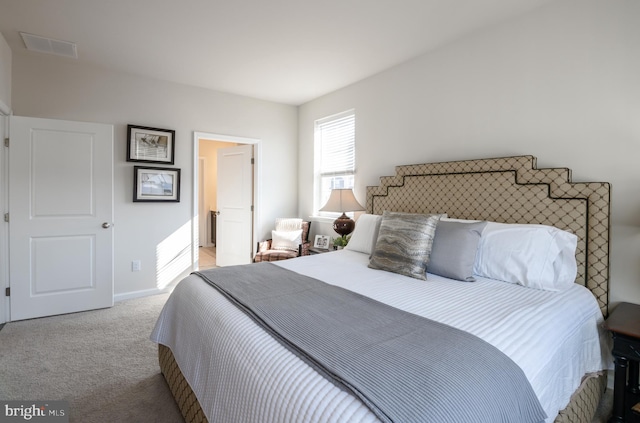 bedroom with carpet, visible vents, and baseboards