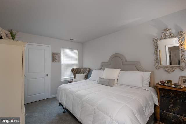 carpeted bedroom featuring visible vents