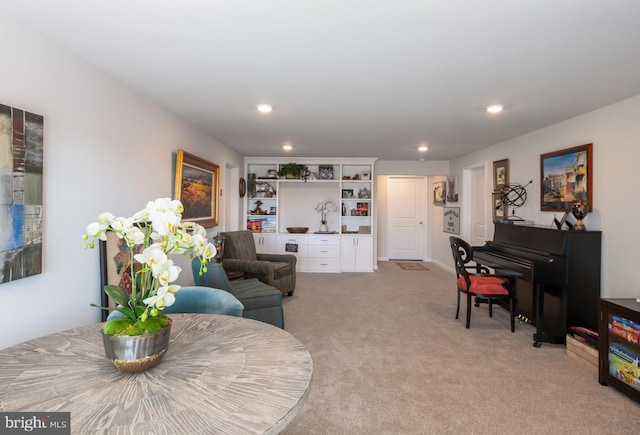 living room with recessed lighting and light colored carpet