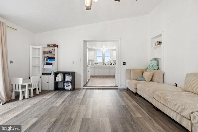 living room featuring ceiling fan and wood finished floors