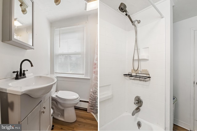 bathroom featuring toilet, baseboard heating, shower / tub combo, wood finished floors, and vanity