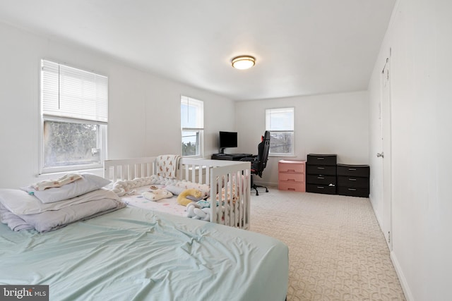 carpeted bedroom featuring baseboards