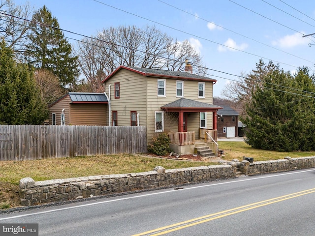 view of front of home with a shingled roof, a porch, fence, and a chimney